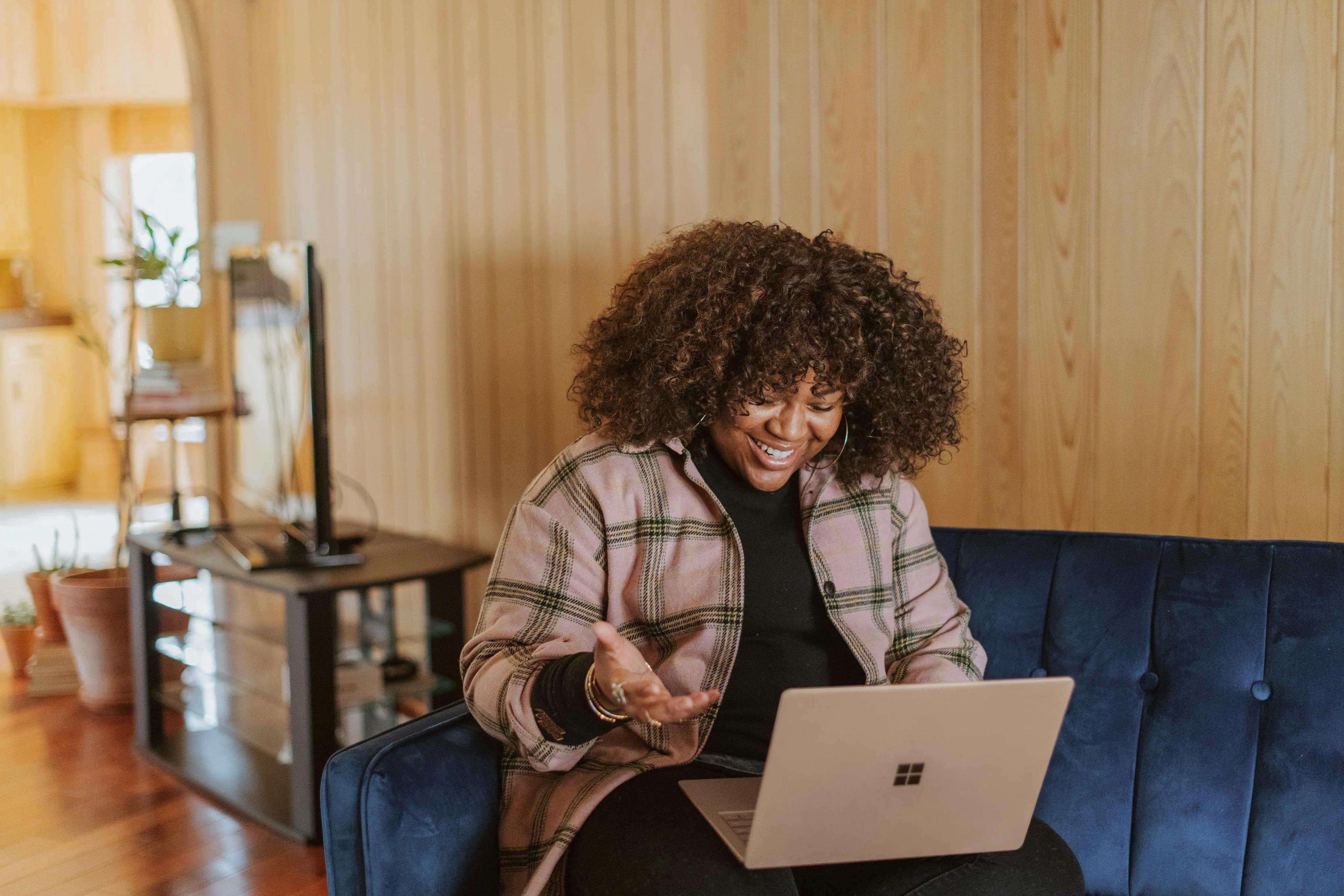 Woman laughing with laptop